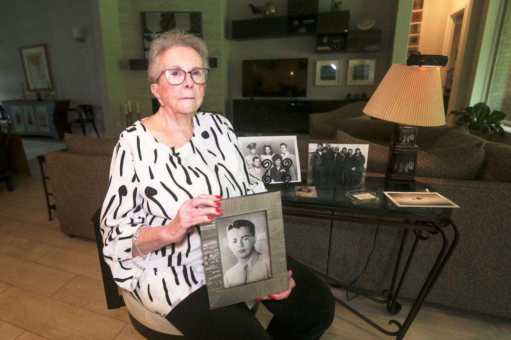 FILE - June West Brandt, 93, holds a photo displaying her brother, William Durham West Jr., who was killed in World War II, Aug. 27, 2025, in Richmond, Texas. (AP Photo/Lekan Oyekanmi, File)
