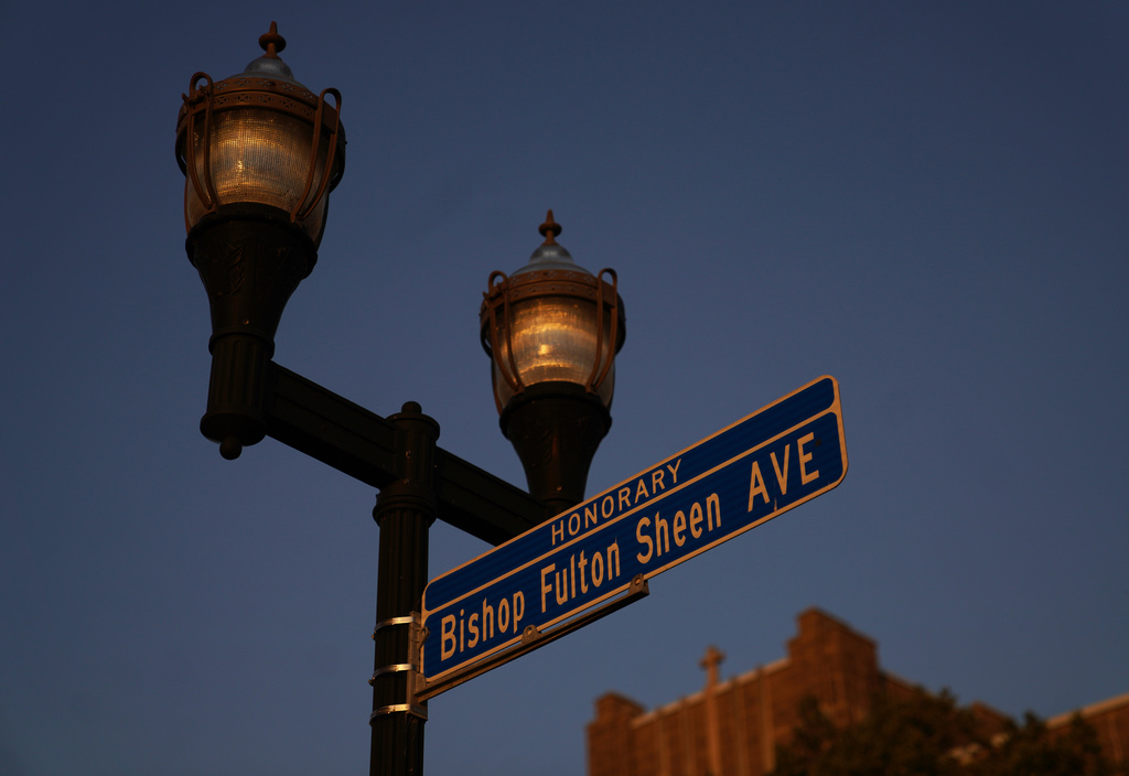 An honorary street sign for the late Archbishop Fulton Sheen stands just outside the Spalding Institute, the former high school Sheen attended, in Peoria, Ill., on July 14, 2026. (AP Photo/Jessie Wardarski)