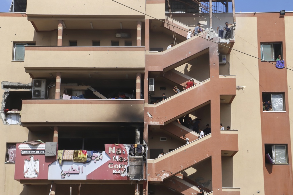 People walk up the stairs to the site of an Israeli strike, minutes before a second strike hit the same spot, killing at least 22 people in total, including five journalists, at Nasser Hospital in Khan Younis, southern Gaza Strip, Monday, Aug. 25, 2025. This was one of the last photos taken by journalist Mariam Dagga, who freelanced for The Associated Press and other outlets, before she walked to the site and was killed in the second strike. (AP Photo/Mariam Dagga)