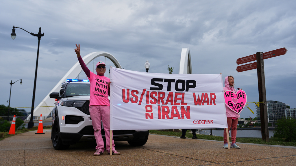 Supporters of Guido Reichstadter, 45, are seen near the Frederick Douglass Bridge, Wednesday, May 6, 2026 in Washington. Reichstadter has come down, after his 6-day protest. (AP Photo/Julia Demaree-Nikhinson)