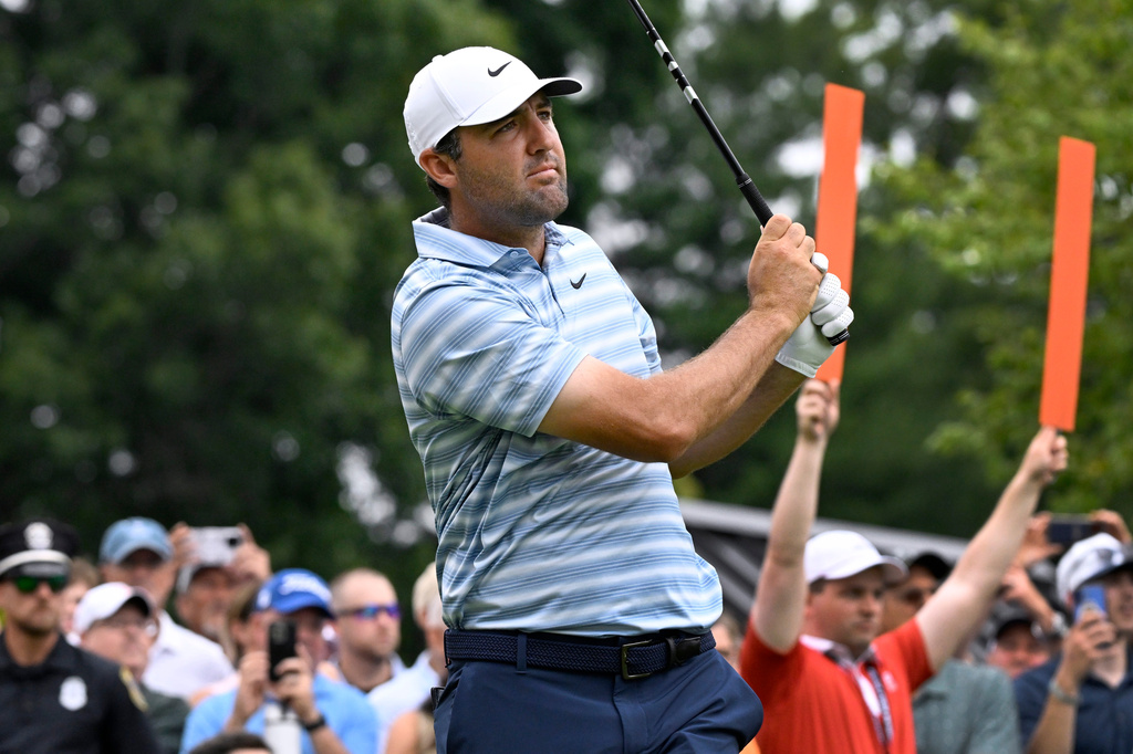 Scottie Scheffler hits at the first tee during the second round of the Travelers Championship golf tournament at TPC River Highlands, Friday, June 26, 2026, in Cromwell, Conn. (AP Photo/Jessica Hill)