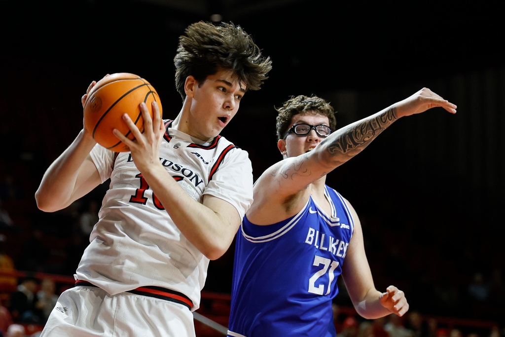 Davidson guard Ian Platteeuw, left, pulls down a rebound against Saint Louis center Robbie Avila during the first half of an NCAA college basketball game in Davidson, N.C., Tuesday, Feb. 3, 2026. (AP Photo/Nell Redmond)