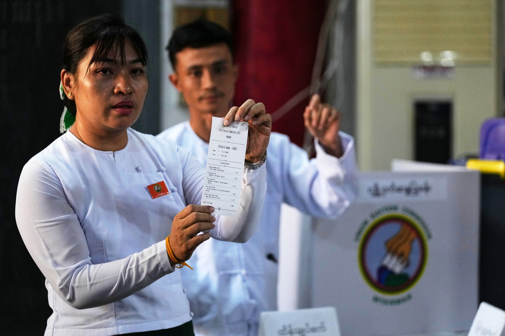 An official of the Union Election Commission shows a slip as they count ballots at a polling station during the second phase of general election in Yangon, Myanmar, Sunday, Jan. 11, 2026. (AP Photo/Thein Zaw)