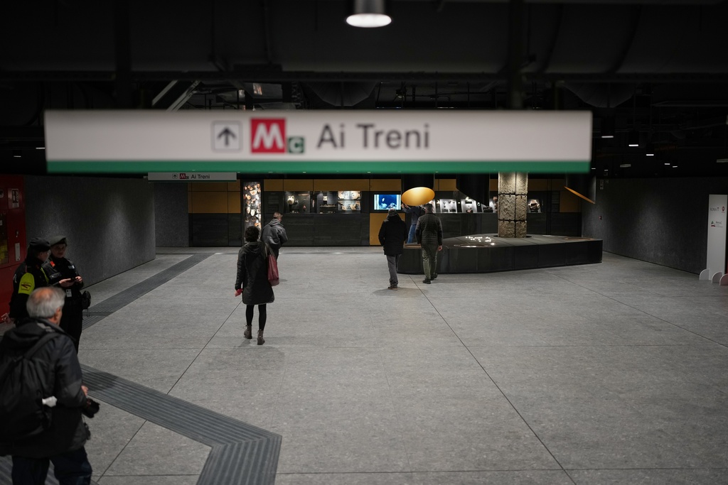 People walk in the hall of the 'Colosseo' new subway station in Rome, Tuesday, Dec. 16, 2025. (AP Photo/Alessandra Tarantino)