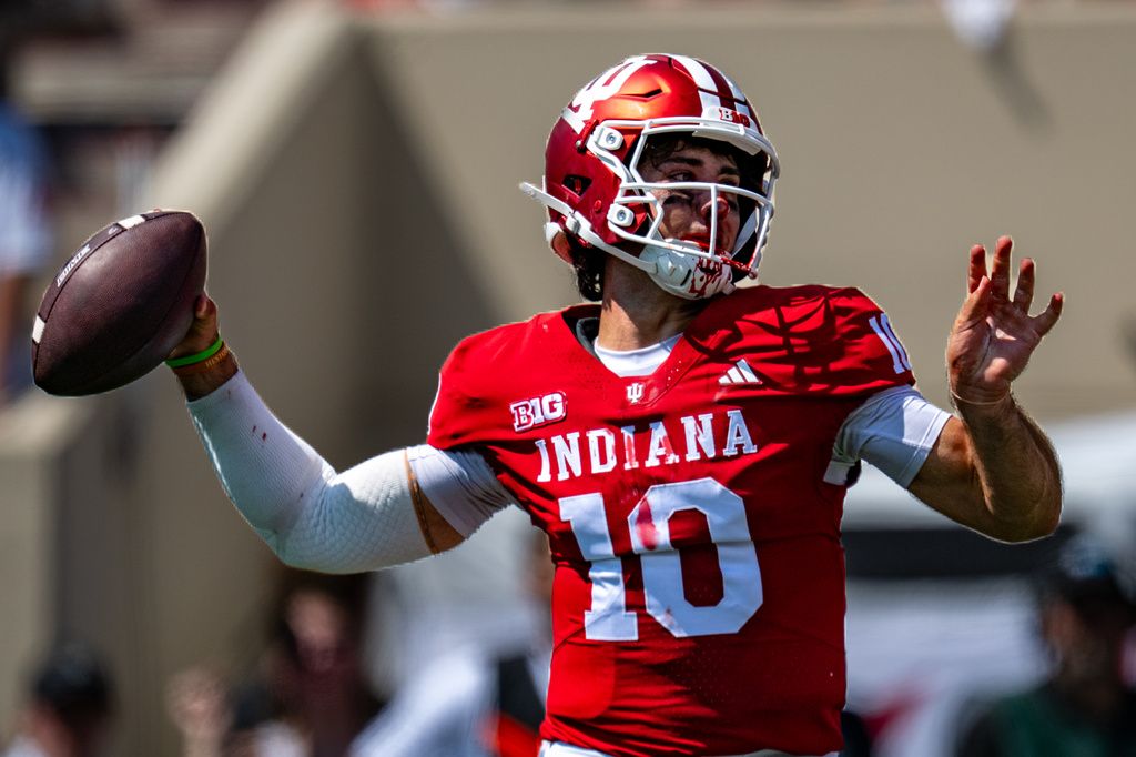 A bloodied Indiana quarterback Josh Hoover (10) looks to pass during the first half of an NCAA college football game against North Texas, Saturday, Sept. 5, 2026, in Bloomington, Ind. (AP Photo/Doug McSchooler)