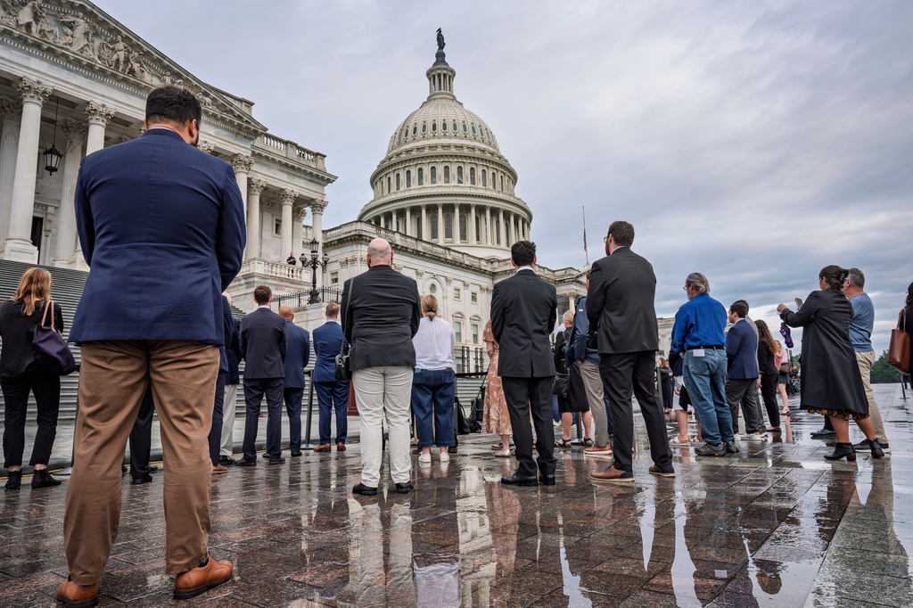 People stand on the East Plaza of the Capitol for a moment of silence as America observes the 25th anniversary of the 9/11 attacks, in Washington, Friday, Sept. 11, 2026. (AP Photo/J. Scott Applewhite)