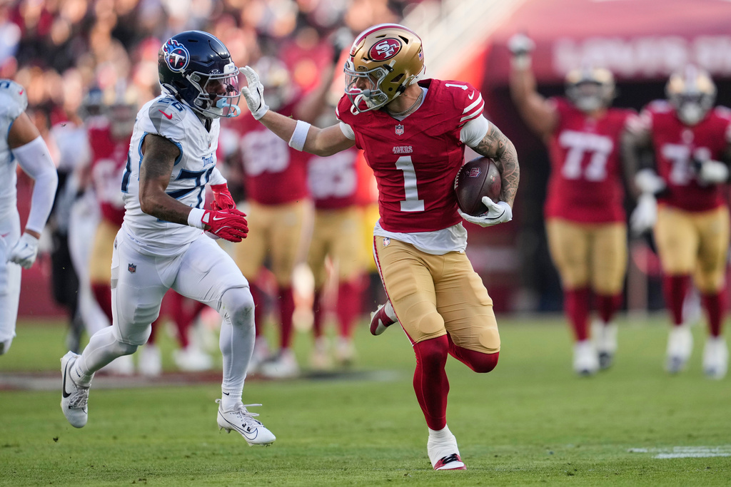 San Francisco 49ers wide receiver Ricky Pearsall (1) gains a first down after a catch past Tennessee Titans cornerback Marcus Harris (26) during the second half of an NFL football game, Sunday, Dec. 14, 2025, in Santa Clara, Calif. (AP Photo/Godofredo A. Vásquez)