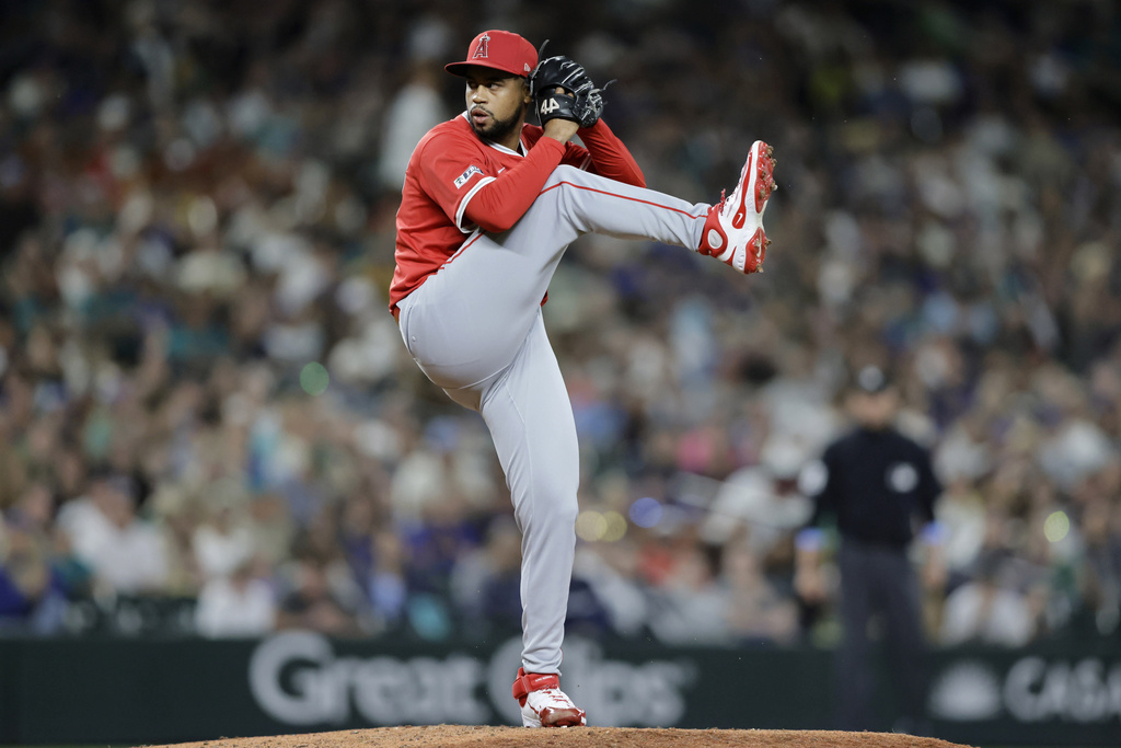 Los Angeles Angels pitcher Sammy Peralta winds up to throw against the Seattle Mariners during the sixth inning of a baseball game Saturday, Sept. 13, 2025, in Seattle. (AP Photo/John Froschauer)