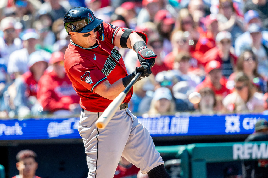 Arizona Diamondbacks' James McCann hits an RBI double in the second inning of a baseball game against the Philadelphia Phillies, Sunday, April 12, 2026, in Philadelphia. (AP Photo/Laurence Kesterson)
