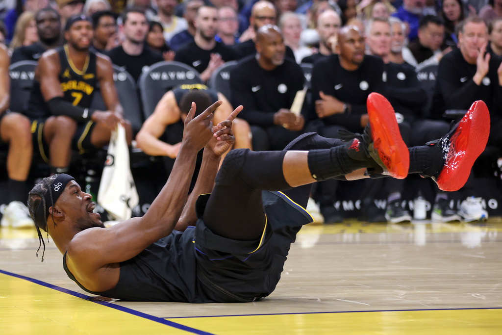Golden State Warriors' Jimmy Butler III reacts to a basket and a foul in the first half of an NBA basketball game against Miami Heat in San Francisco on Monday, Jan. 19, 2026. (Scott Strazzante/San Francisco Chronicle via AP)