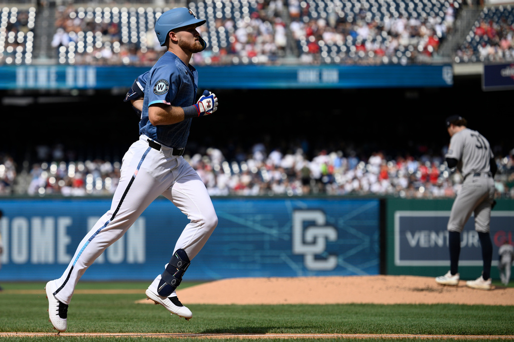 Washington Nationals' Curtis Mead, left, rounds the bases on his solo home run off New York Yankees pitcher Cam Schlittler (31) during the first inning of a baseball game Saturday, July 11, 2026, in Washington. (AP Photo/Nick Wass)