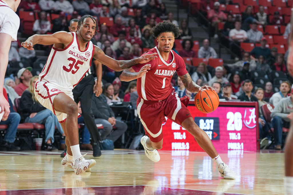 Alabama guard Jalil Bethea (1) drives past Oklahoma forward Derrion Reid (35) during the first half of an NCAA college basketball game, Saturday, Jan. 17, 2026, in Norman, Okla. (AP Photo/Kyle Phillips)