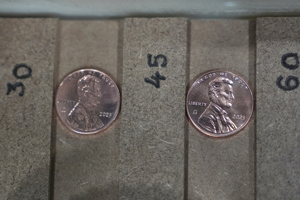 Two of the last five pennies pressed at the U.S. Mint are presented during a news conference in Philadelphia, Wednesday, Nov. 12, 2025. (AP Photo/Matt Slocum)