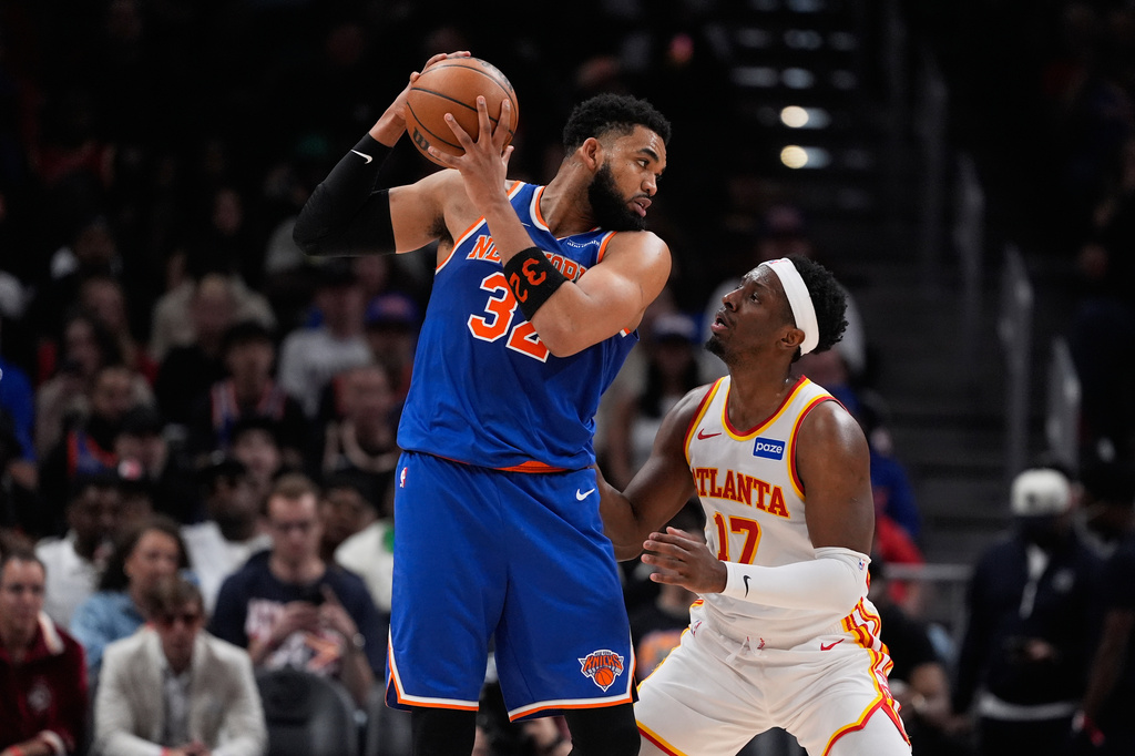 New York Knicks center Karl-Anthony Towns (32) blocks Atlanta Hawks forward Onyeka Okongwu (17) in the first half during Game 6 in a first-round NBA basketball playoffs series Thursday, April 30, 2026, in Atlanta. (AP Photo/Brynn Anderson)