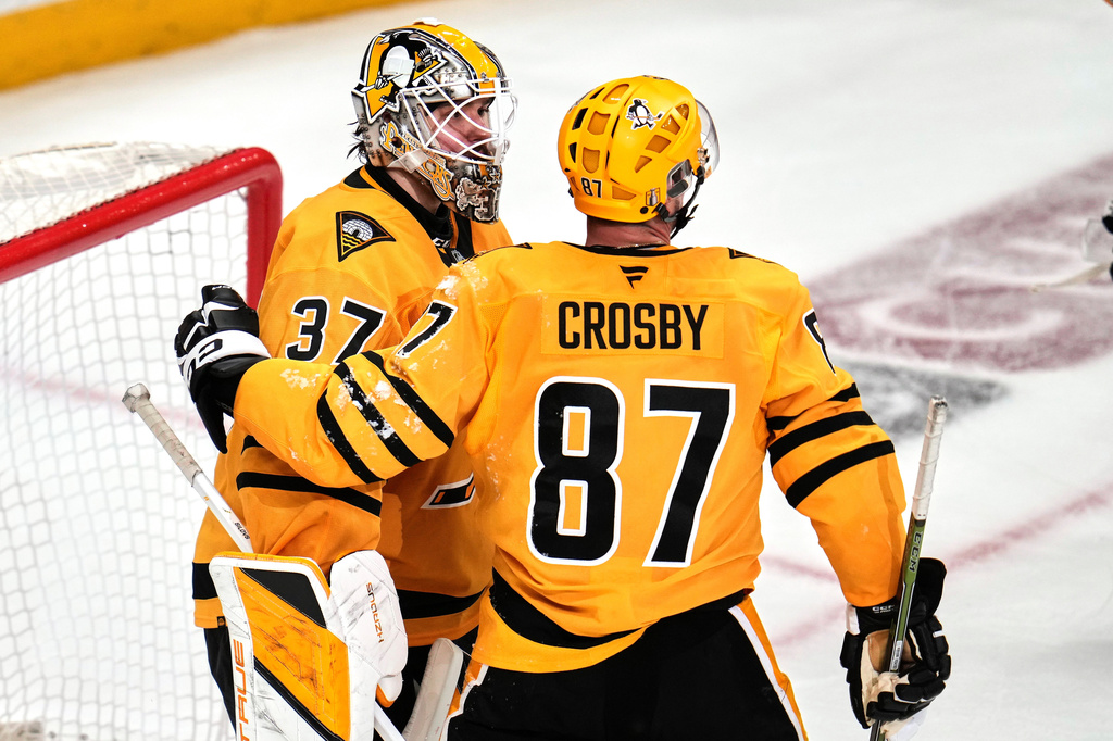 Pittsburgh Penguins goaltender Arturs Silovs (37) celebrates with Sidney Crosby (87) at the end of Game 5 in the first round of an NHL hockey Stanley Cup playoff series in Pittsburgh, Monday, April 27, 2026. (AP Photo/Gene J. Puskar)
