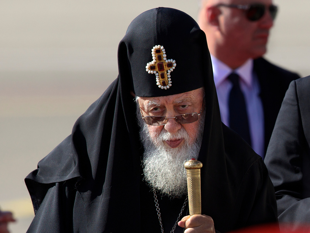 FILE - Georgian Orthodox Patriarch Ilia II, listens to the national anthem during a welcoming ceremony for Pope Francis in Tbilisi, Georgia, Sept. 30, 2016. (AP Photo/Ivan Sekretarev, File)