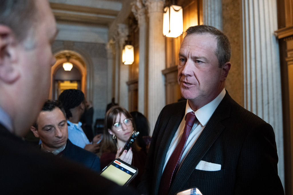 Sen. Eric Schmitt, R-Mo., speaks to members of the media at the Capitol, Thursday, Feb. 12, 2026, in Washington. (AP Photo/Allison Robbert)