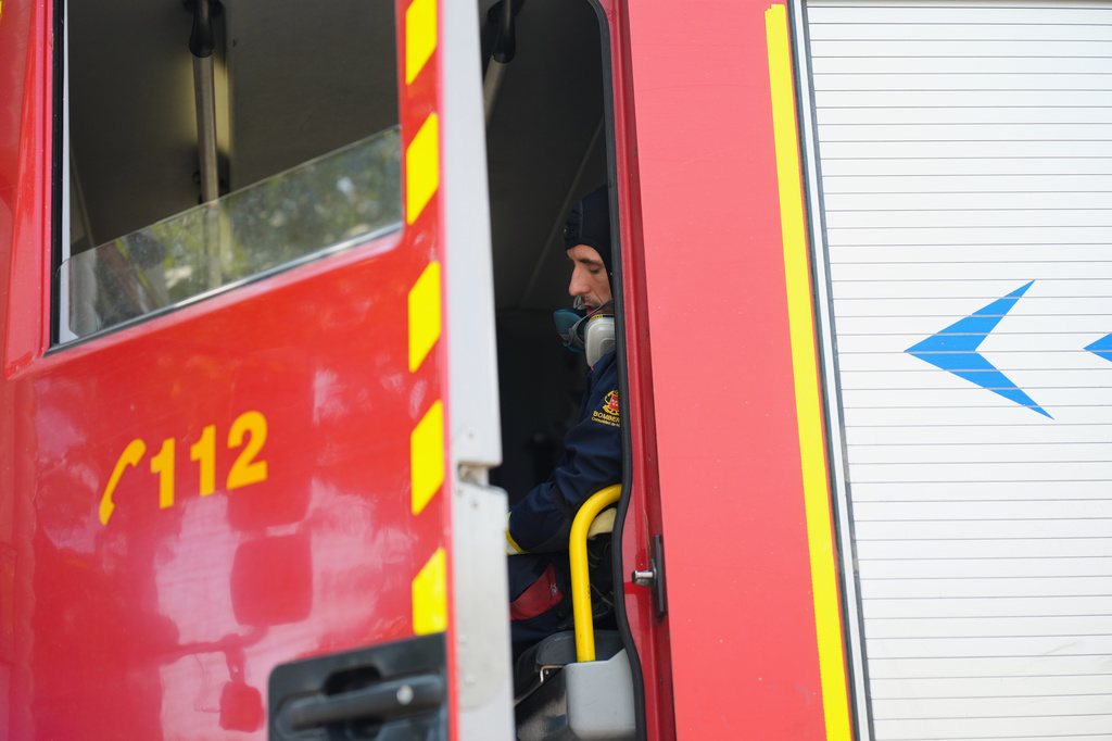 A firefighter rests inside a fire engine in San Martin de Valdeiglesias, west of Madrid, Spain, where wildfires have forced tens of thousands to be evacuated, Sunday, July 26, 2026. (AP Photo/Manu Fernandez)
