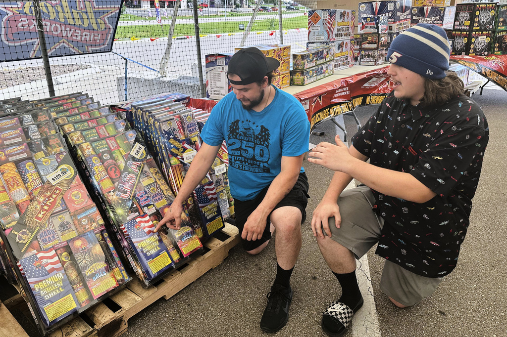 Joe Fuqua-Bejarano, left, and his brother, Blake, manage Jake’s Fireworks stand on Tuesday, June 30, 2026, in Topeka, Kan. (AP Photo/John Hanna)