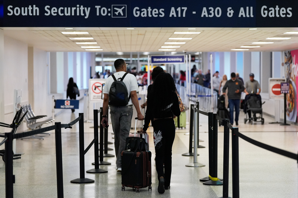 FILE - Travelers walk through TSA security lines at George Bush Intercontinental Airport on March 30, 2026, in Houston. (AP Photo/Ashley Landis, File)