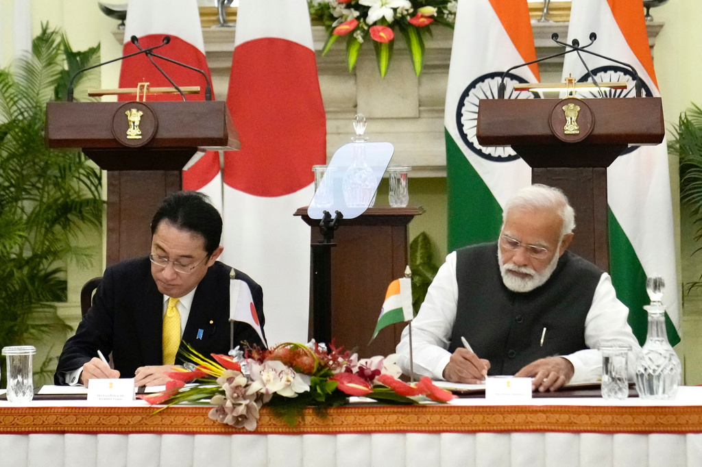 FILE - Indian Prime Minister Narendra Modi, right, and his Japanese counterpart Fumio Kishida sign agreements in New Delhi, March 19, 2022. (AP Photo/Manish Swarup, File)