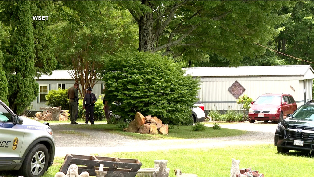 This image taken from video shows law enforcement at the scene of Michael Puckett's home in Carroll County, Va., on Saturday, May 30, 2026. (WSET via AP)