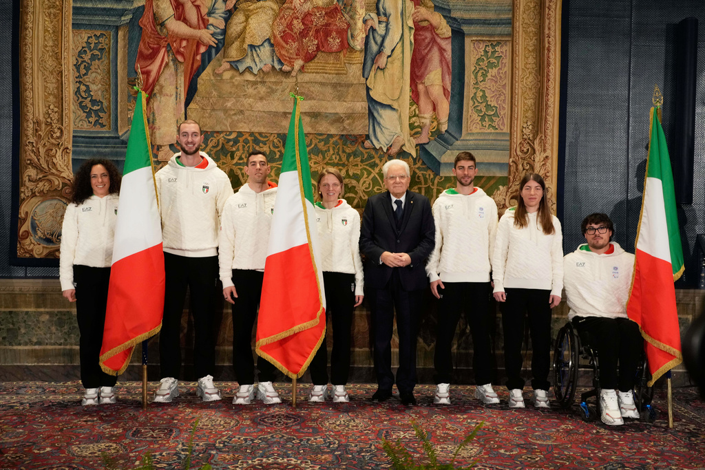 From left, Italian athletes Federica Brignone, Amos Mosaner, Federico Pellegrino, Arianna Fontana, Italian President Sergio Mattarella, Rene' de Silvestro, right, and Chiara Mazzel, second from right, pose for a group photo, during the hand over ceremony of the Italian flag for the Milan-Cortina Winter Olympic games, at the Quirinale Presidential palace, in Rome, Monday, Dec. 22, 2025. (AP Photo/Gregorio Borgia)