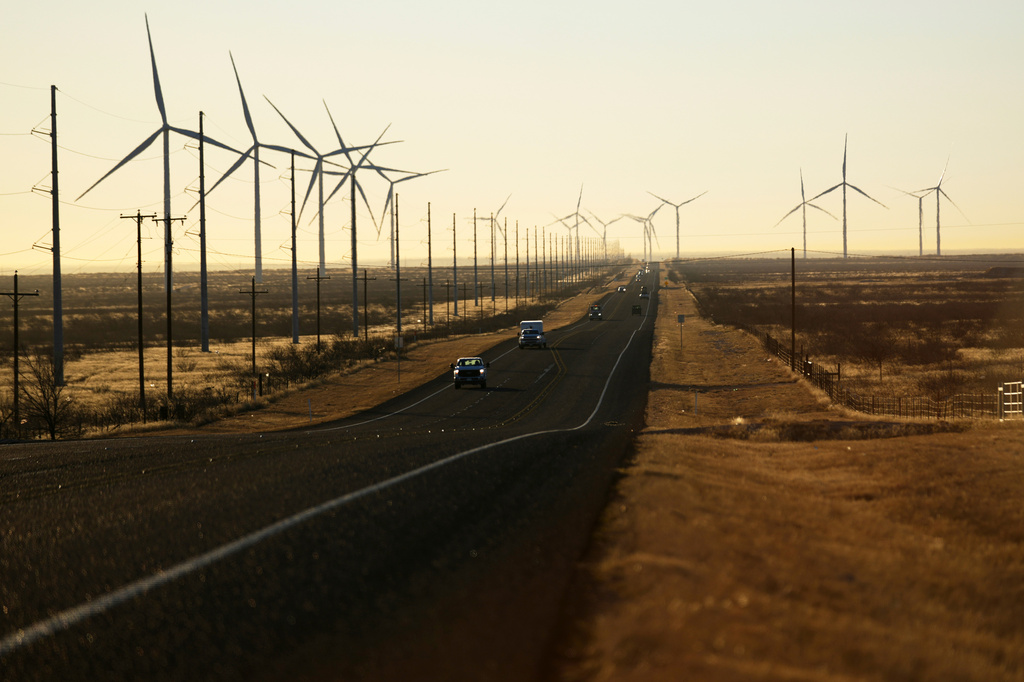 FILE - Wind turbines are visible along Route 176 as vehicles travel eastbound Feb. 24, 2025, in Andrews, Texas. (AP Photo/Julio Cortez, File)