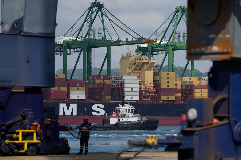 Cranes load and unload containers from cargo ships at the Panama Canal's Rodman Port, operated by PSA International, in Panama City, Thursday, April 9, 2026. (AP Photo/Matias Delacroix)