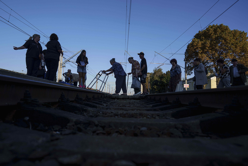 People walk on a platform during evacuation at the train station in Lozova, Ukraine, Wednesday, Sept. 3, 2025. (AP Photo/Evgeniy Maloletka)