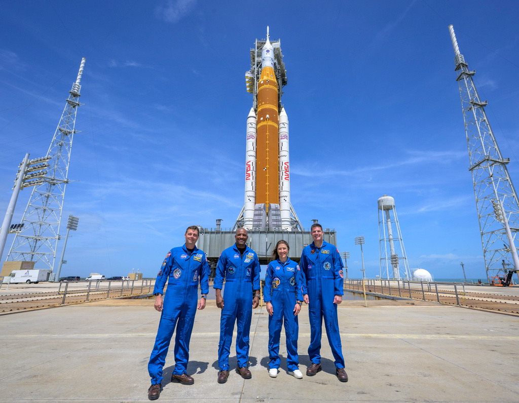 This photo provided by NASA shows NASA astronauts Reid Wiseman, Artemis II commander, from left, Victor Glover, Artemis II pilot, Christina Koch, Artemis II mission specialist, and CSA (Canadian Space Agency) astronaut Jeremy Hansen, Artemis II mission specialist, right, in a group photograph as they visit NASA's Artemis II SLS (Space Launch System) rocket and Orion spacecraft, Monday, March 30, 2026, at Launch Complex 39B of NASA's Kennedy Space Center, in Cape Canaveral, Fla. (Bill Ingalls/NASA via AP)