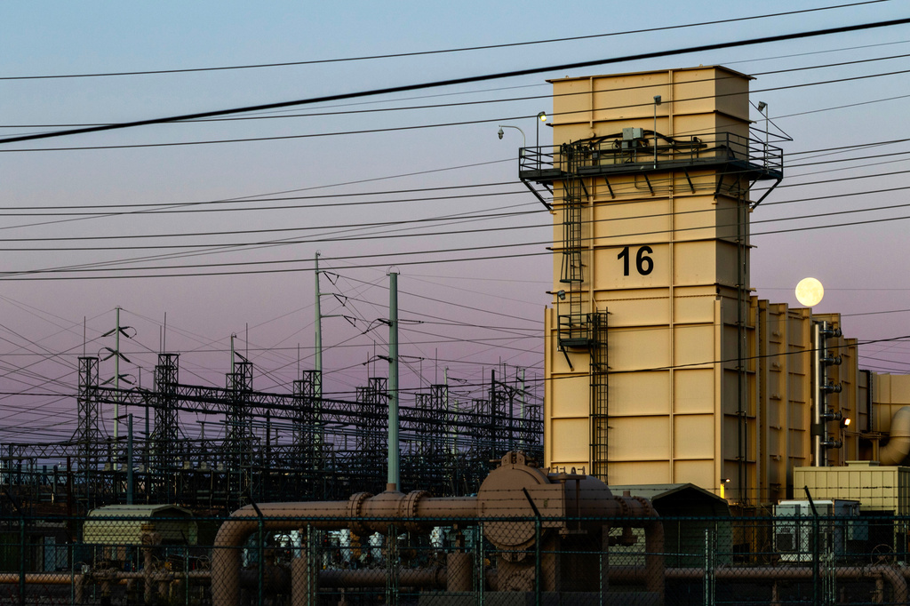 The moon sets over the Edward Clark Generating Station, which runs on natural gas, Friday, April 3, 2026, in Las Vegas. (AP Photo/Ty ONeil)