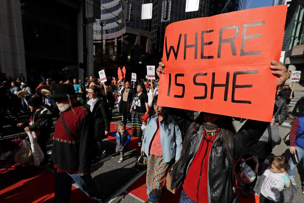 FILE - Dennis Willard, of Bellevue, Wash., carries a sign that reads "Where Is She" as he marches in support of missing and murdered indigenous women during a rally to mark Indigenous Peoples' Day in downtown Seattle, on Oct. 14, 2019. (AP Photo/Ted S. Warren, File)