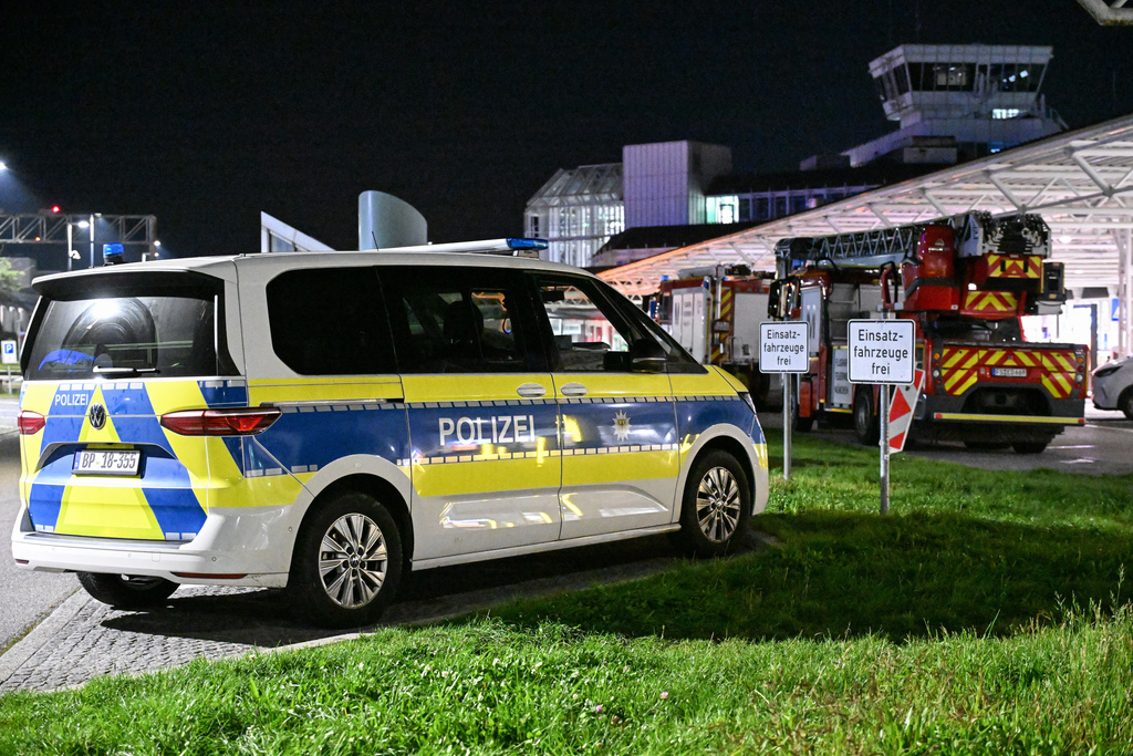 Police and fire department are on duty after drone sightings and flight cancellations at Munich Airport, Friday, Oct.3, 2025. (Jason Tschepljakow/dpa via AP)