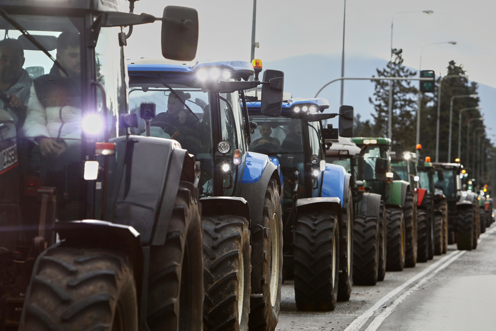 Farmers with their tractors try to block the main access road to Thessaloniki's international airport, northern Greece, Friday, Dec. 5, 2025, as protests over delays in European Union-backed agricultural subsidy payments escalated. (AP Photo/Giannis Papanikos)