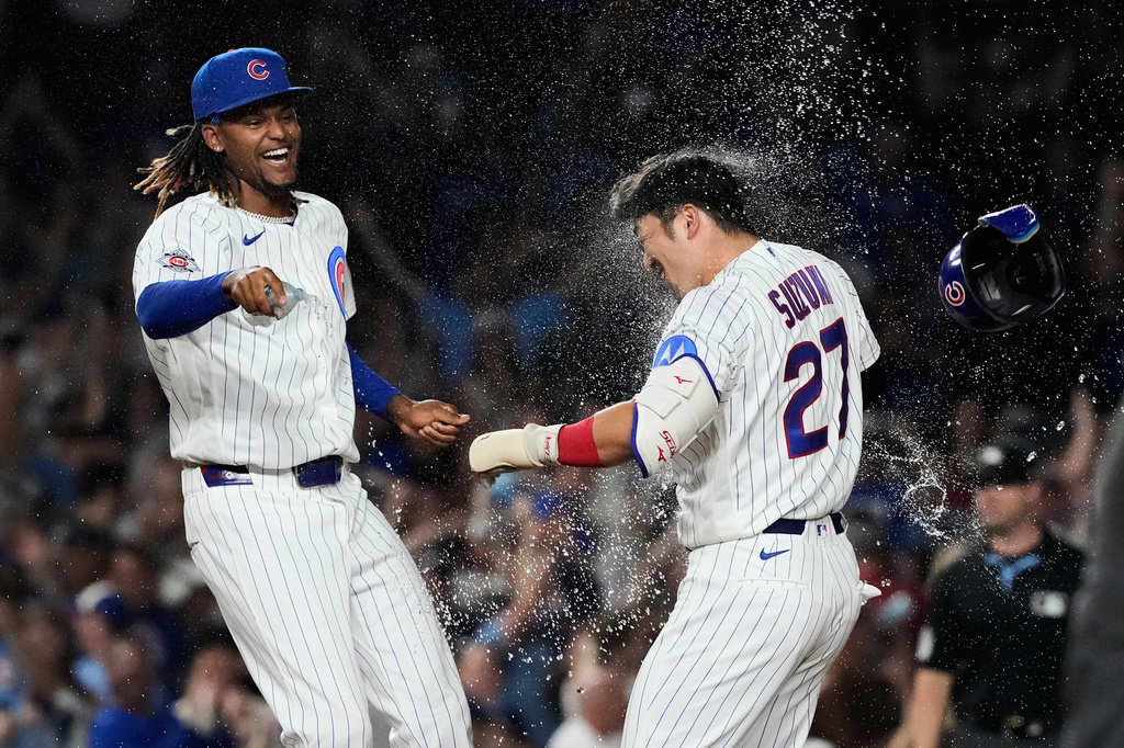 Chicago Cubs' Seiya Suzuki, right, of Japan, celebrates with a teammate after hitting a walk-off one-run single during the ninth inning of a baseball game against the San Diego Padres in Chicago, Monday, June 29, 2026. (AP Photo/Nam Y. Huh)