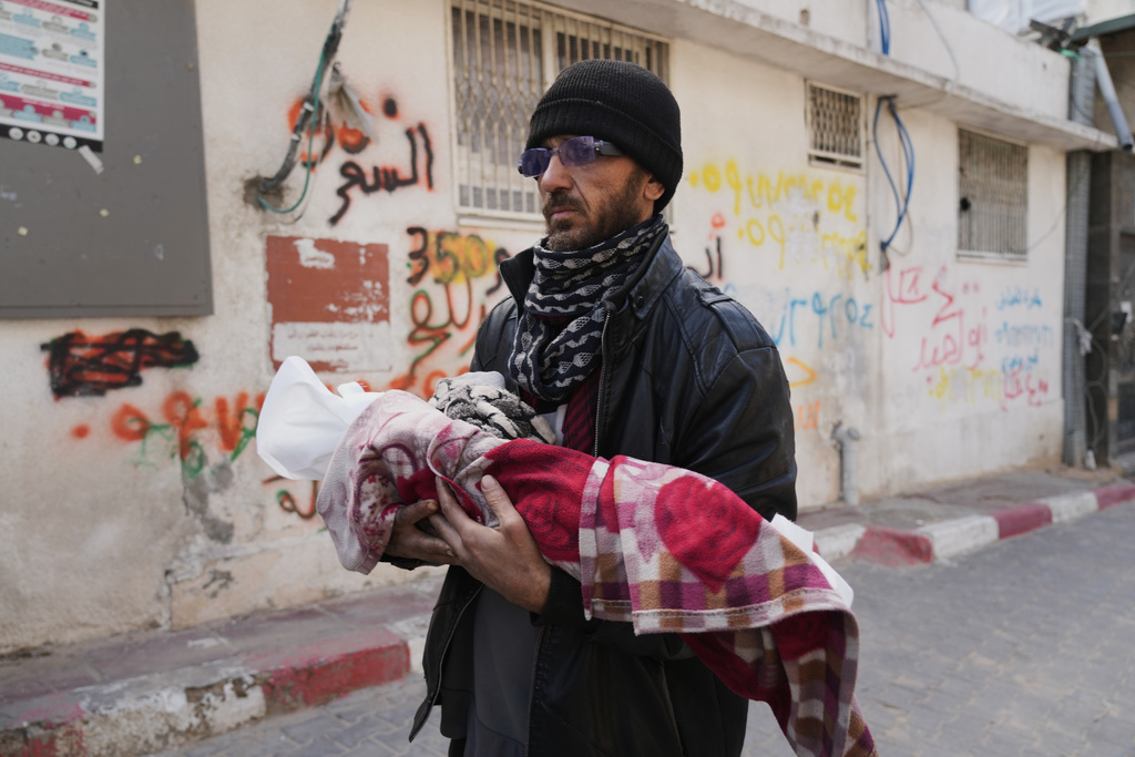 Khalid Abu Jarad holds the body of his 3-month-old niece, Shaza Abu Jarad, who, according to the health ministry, died from hypothermia, in Gaza City, Tuesday, Jan. 20, 2026. (AP Photo/Jehad Alshrafi)