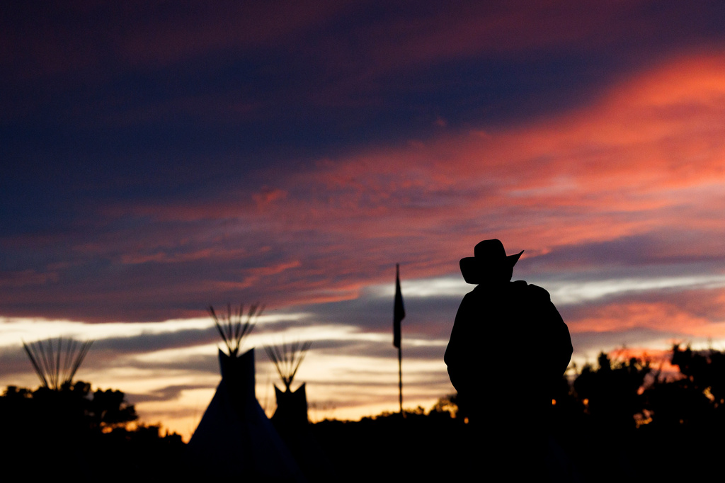 A man walks back to camp during festivities commemorating the 150th anniversary of the Battle of the Little Bighorn, Wednesday, June 24, 2026, in Crow Agency, Mont. (AP Photo/Tailyr Irvine)