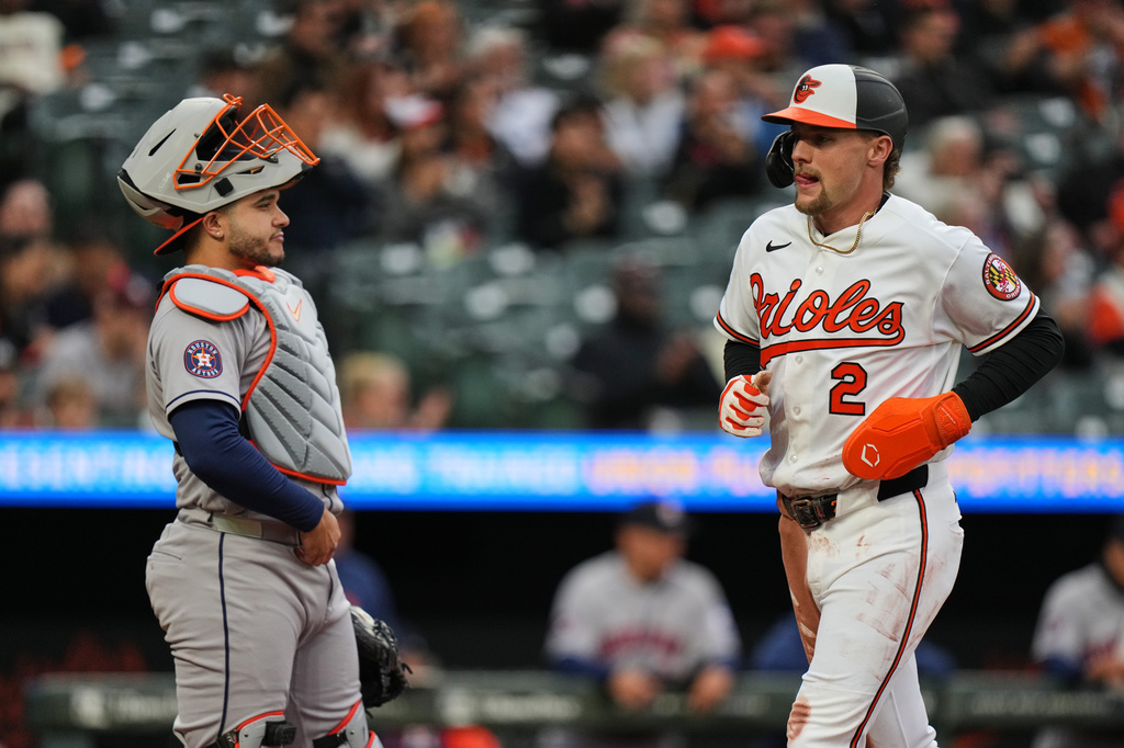 Baltimore Orioles Gunnar Henderson (2) scores past Houston Astros catcher Yainer Diaz, left, on an RBI hit by Orioles' Adley Rutschman during the first inning of a baseball game, Tuesday, April 28, 2026, in Baltimore. (AP Photo/Stephanie Scarbrough)