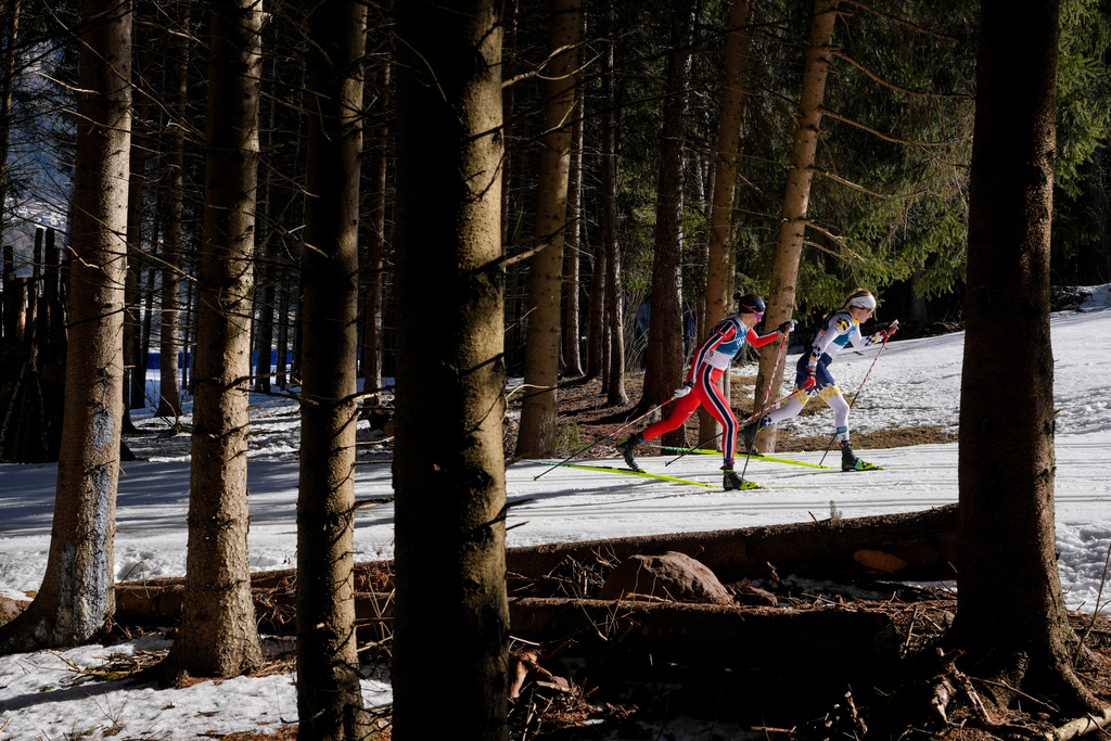 Ebba Andersson, of Sweden, right, and Heidi Weng, of Norway, compete in the cross country skiing women's 50km mass start classic at the 2026 Winter Olympics, in Tesero, Italy, Sunday, Feb. 22, 2026. (AP Photo/Evgeniy Maloletka)