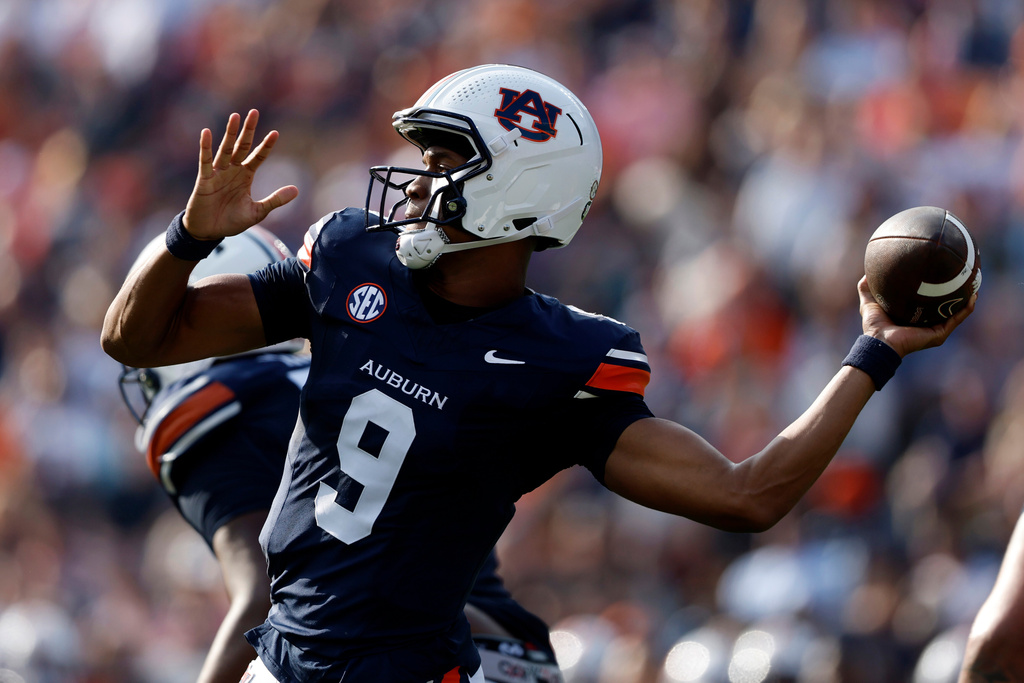 Auburn quarterback Deuce Knight (9) throws a pass during the first half of an NCAA college football game against Mercer, Saturday, Nov. 22, 2025, in Auburn, Ala. (AP Photo/Butch Dill)