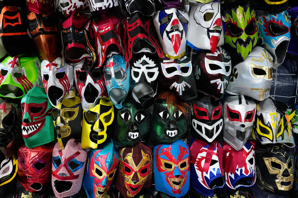 Lucha Libre wrestling masks hang for sale outside Arena Mexico in Mexico City, Friday, June 26, 2026. (AP Photo/Marco Ugarte)