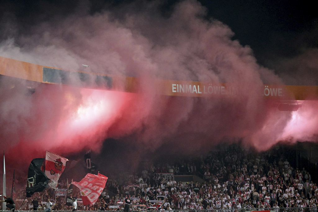 Fans set off pyrotechnics during a DFB Pokal, German Cup, soccer match between VfB Stuttgart and Eintracht Braunschweig, Tuesday, Aug. 26, 2205, in Brunswick, Germany. (Swen Pförtner/dpa via AP)
