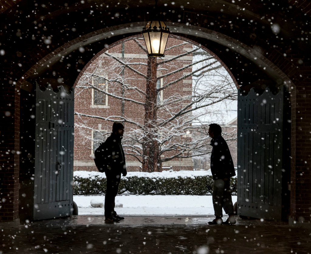 FILE - Wheaton College students stop to chat on the Norton, Mass. campus, Feb. 13, 2024 as snow falls. (Mark Stockwell/The Sun Chronicle via AP, File)