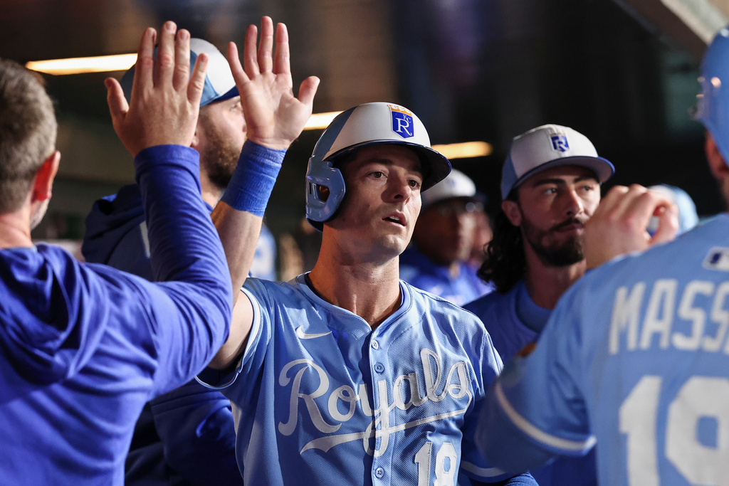 Kansas City Royals' Mike Yastrzemski, center, celebrates in the dugout after scoring during the fifth inning of a baseball game against the Athletics Saturday, Sept. 27, 2025, in West Sacramento, Calif. (AP Photo/Sara Nevis)
