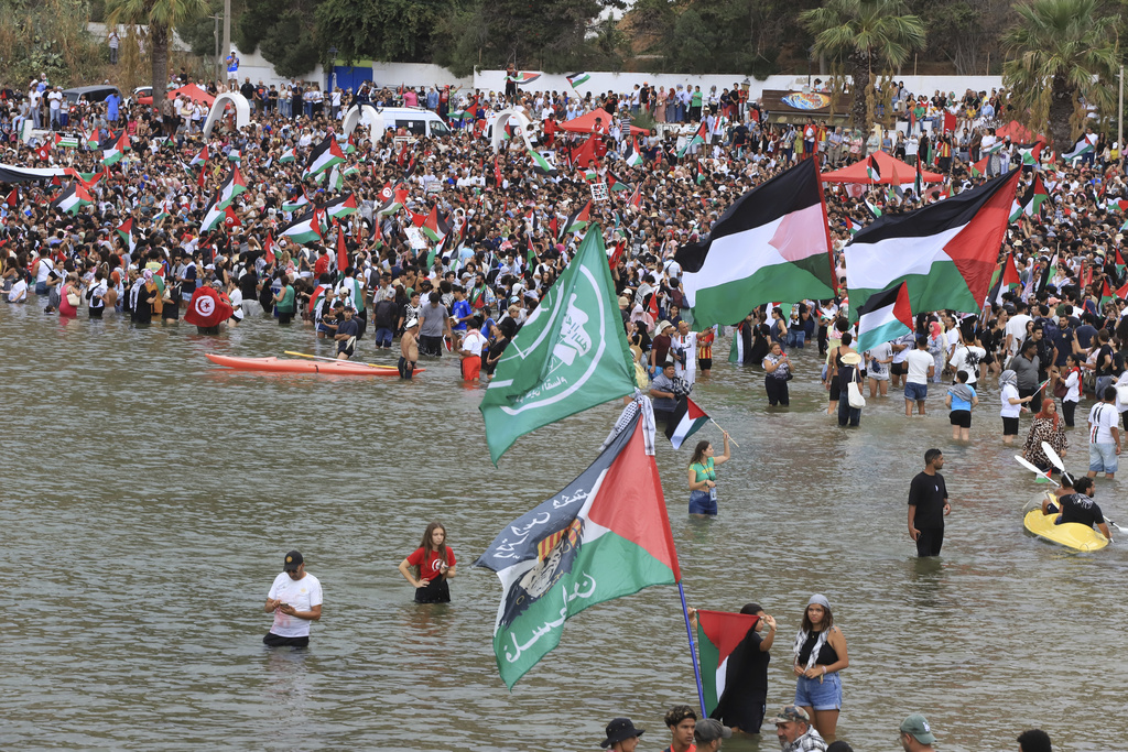 People gather to show support for the Global Sumud Flotilla ahead of its scheduled departure to deliver aid to Gaza amidst Israel's blockade on the Palestinian territory, in Sidi Bou Said port in Tunis, Tunisia, Wednesday, Sept. 10, 2025. (AP Photo/Anis Mili)