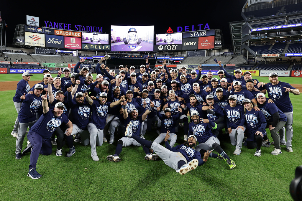 The Tampa Bay Rays take a team photo as they celebrate after defeating the New York Yankees in the second baseball game of a doubleheader Tuesday, Sept. 22, 2026, in New York. (AP Photo/Adam Hunger)