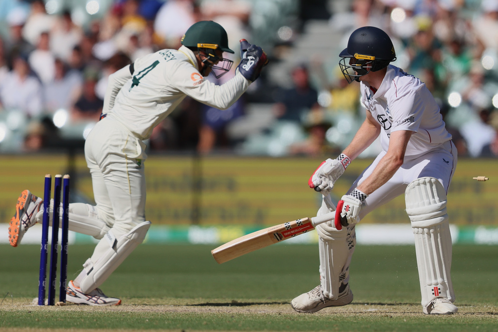 England's Zak Crawley reacts after he was out stumped by Australia's Alex Carey, left, during play on day four of the third Ashes cricket test between England and Australia in Adelaide, Australia, Saturday, Dec. 20, 2025. (AP Photo/James Elsby)