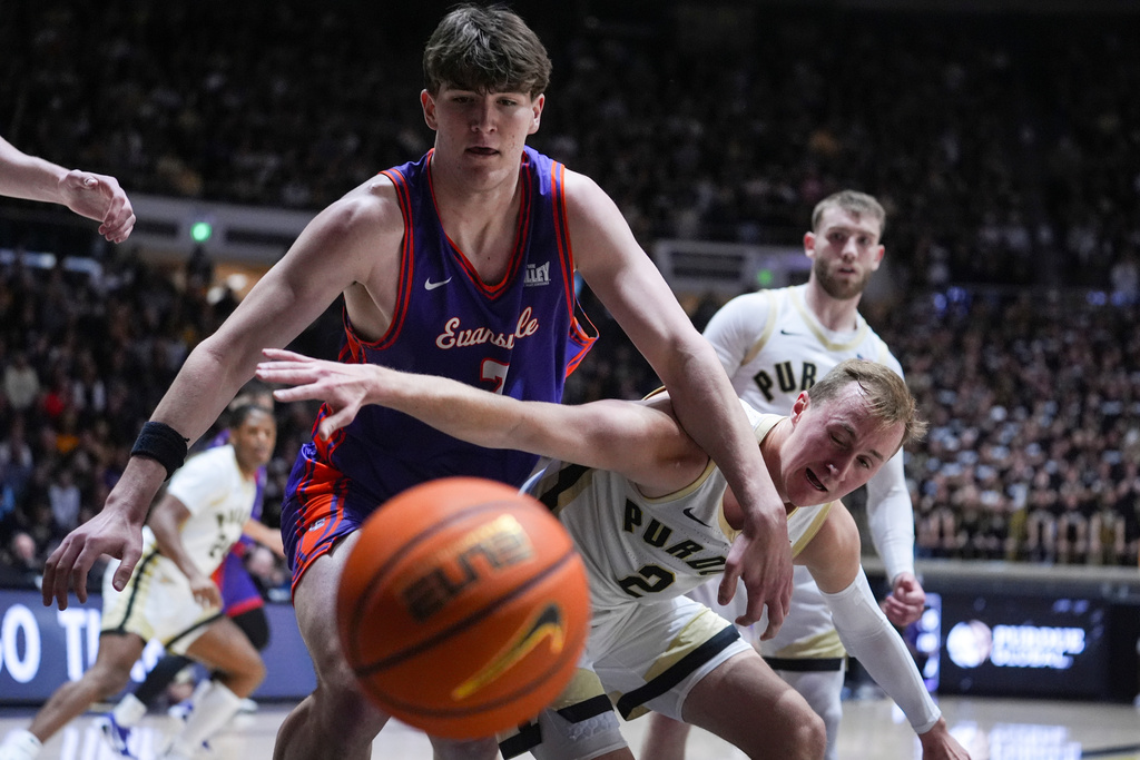 Evansville forward James Dyson-Merwe (2) and Purdue guard Fletcher Loyer (2) go for a loose ball during the first half of an NCAA college basketball game in West Lafayette, Ind., Tuesday, Nov. 4, 2025. (AP Photo/Michael Conroy)