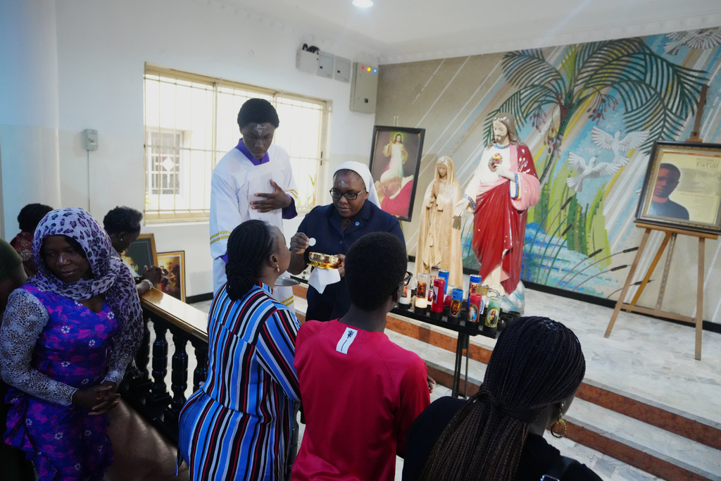 Catholic faithfuls takes holy communion during Ash Wednesday Mass at the church of the Assumption Falomo in Lagos, Nigeria, Wednesday, Feb. 18, 2026. (AP Photo/Sunday Alamba)